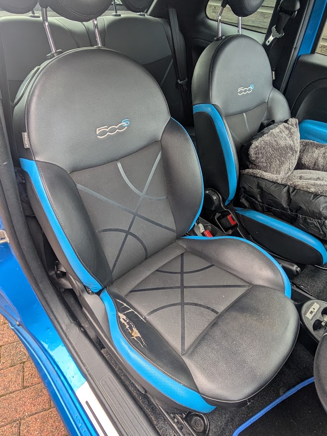 Blue and black vehicle driver's seat before bolster repair
