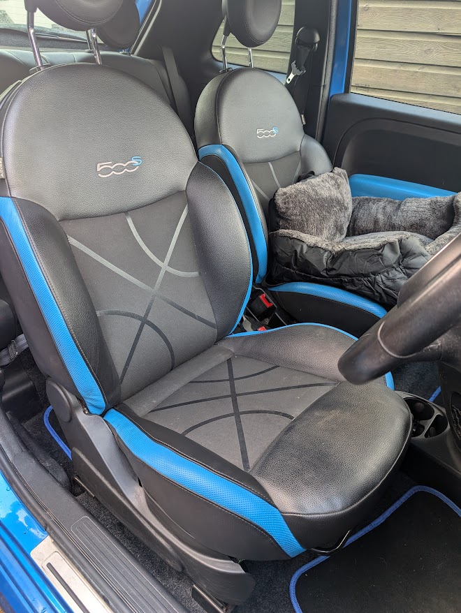 Blue and black vehicle driver's seat after bolster repair